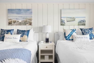 Two beds and nightstand in Risingtide Oceanview Double Efficiency at Chatham Tides Resort