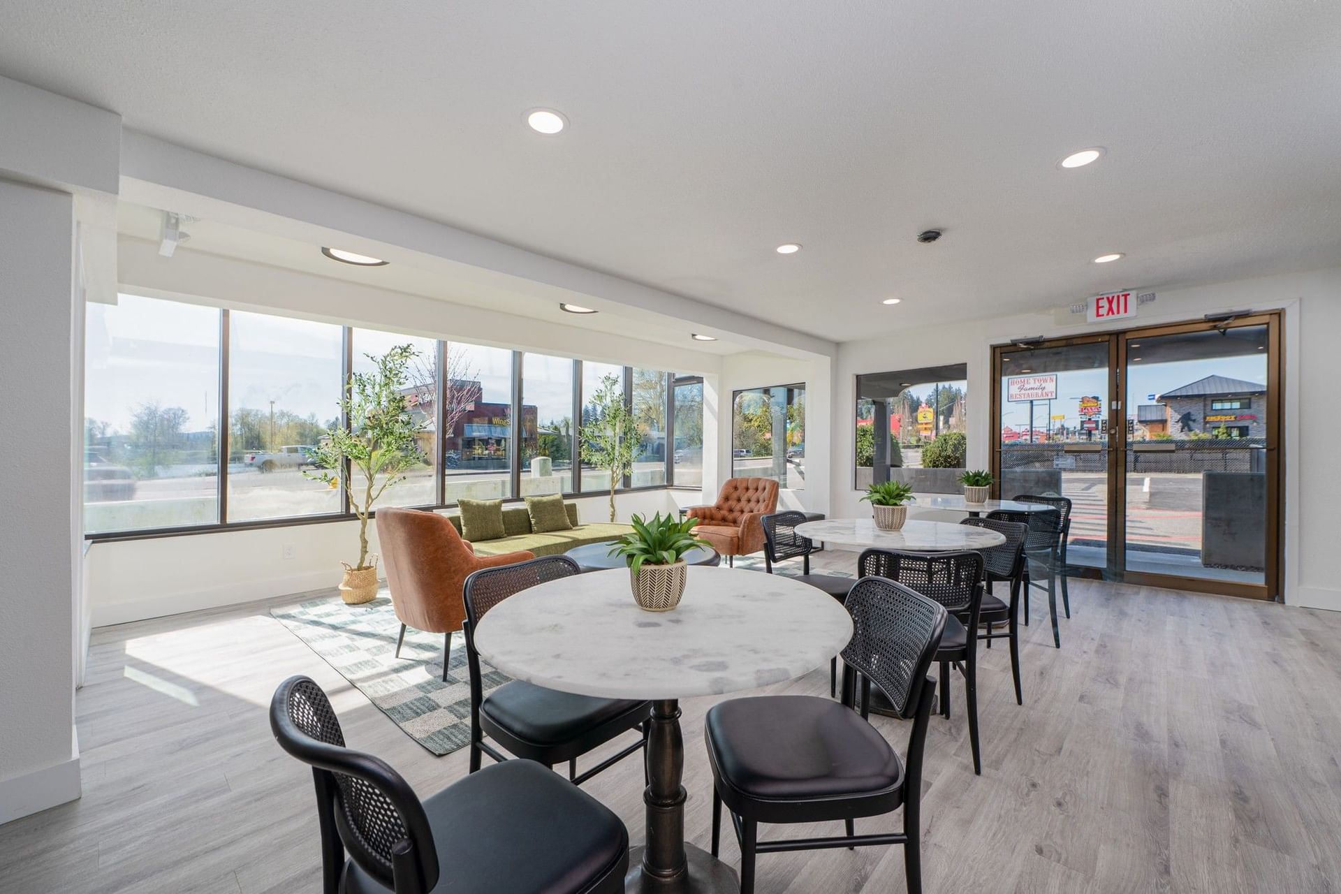 Modern lobby with marble tables & leather chairs, and large windows at The Varsity South