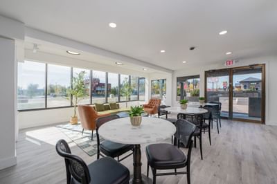 Modern lobby with marble tables & leather chairs, and large windows at The Varsity South