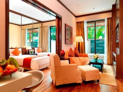 Bedroom & living area with TV & couches in a Suite at MiCasa All Suite Hotel KL