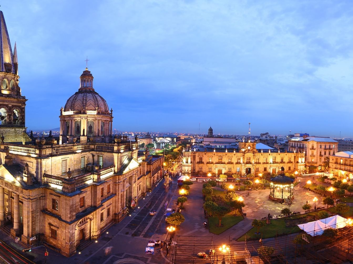 City square with lit Guadalajara Cathedra near One Hotels