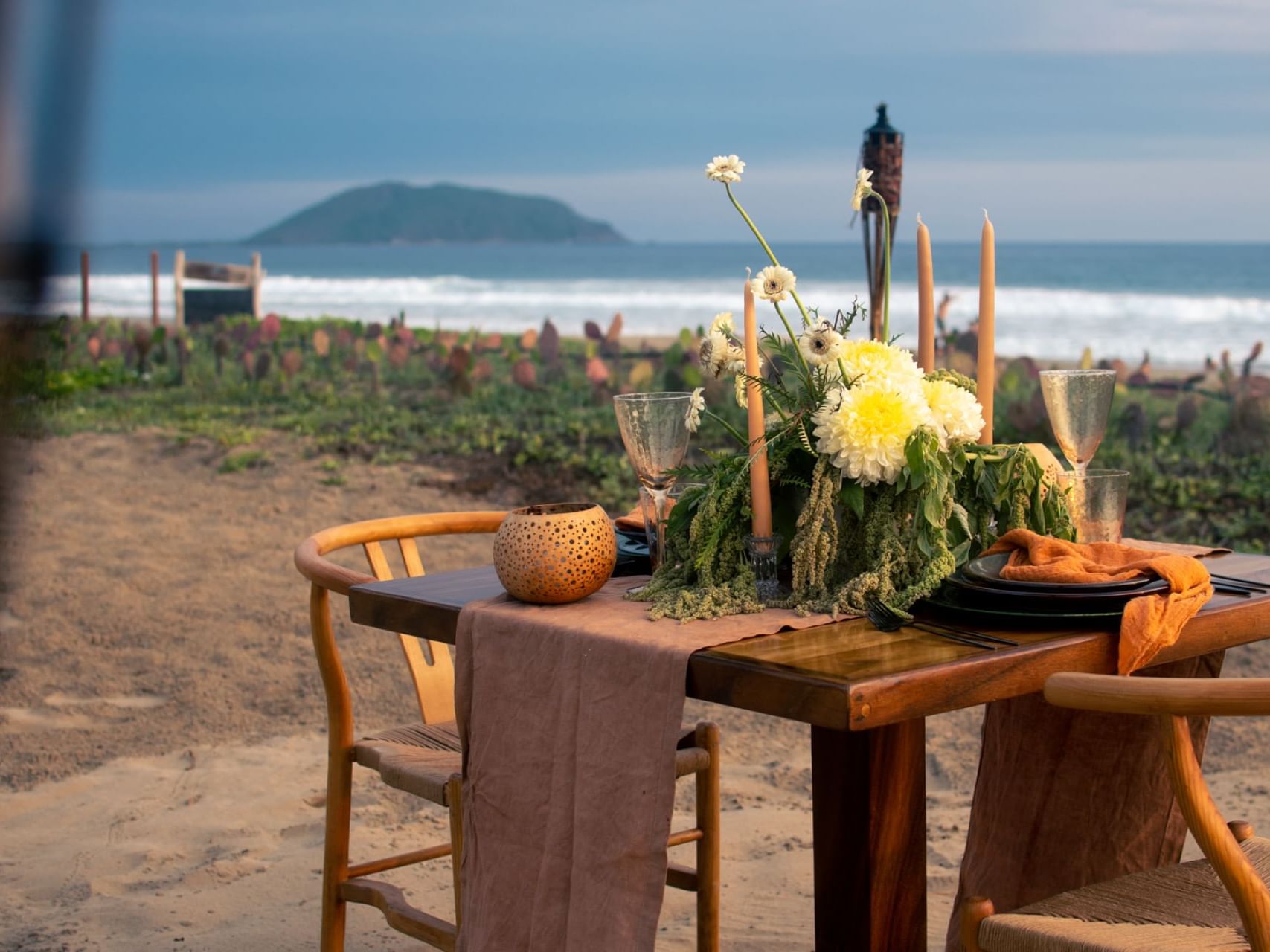 Dining table on the beach near Marea Beachfront Villas