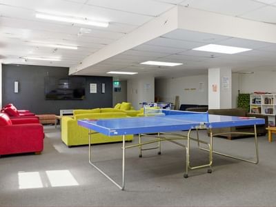Spacious lounge with a ping pong table and comfortable seating at UniLodge Stafford House.