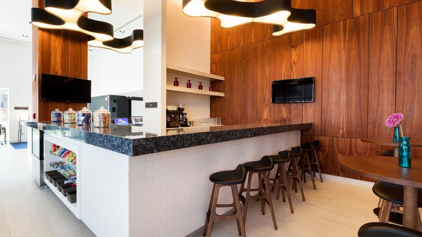 Snack bar with a counter & stools by wood-paneled walls, Cancun Mexican restaurant at Fiesta Inn Express Cancún Cumbres
