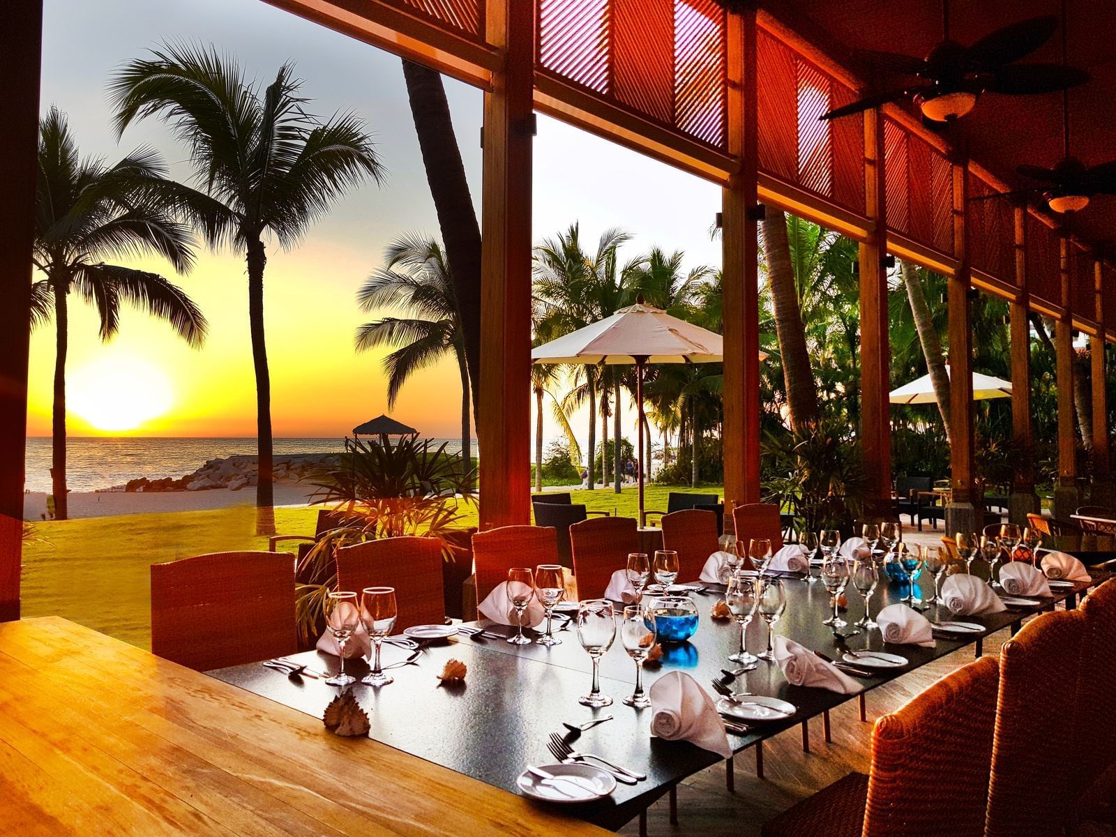Veranda dining area at sunset at La Colección Resorts