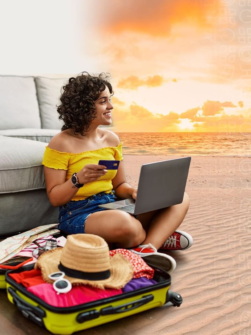 Girl working with laptop near tropical beach at Mundo Imperial