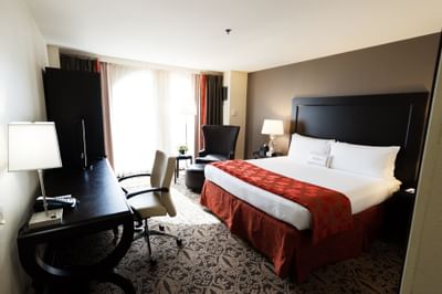 bed in carpeted room with window