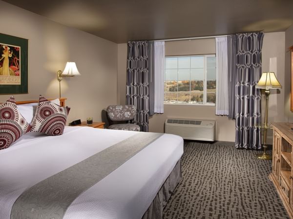 Bed in stylish hotel room with window