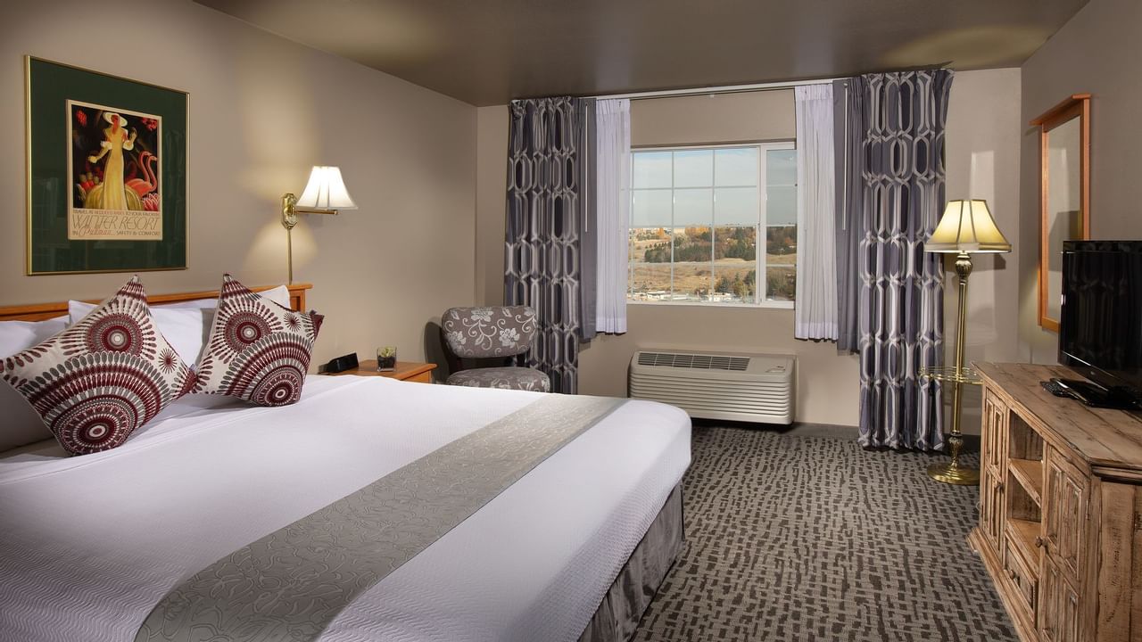 Bed in stylish hotel room with window