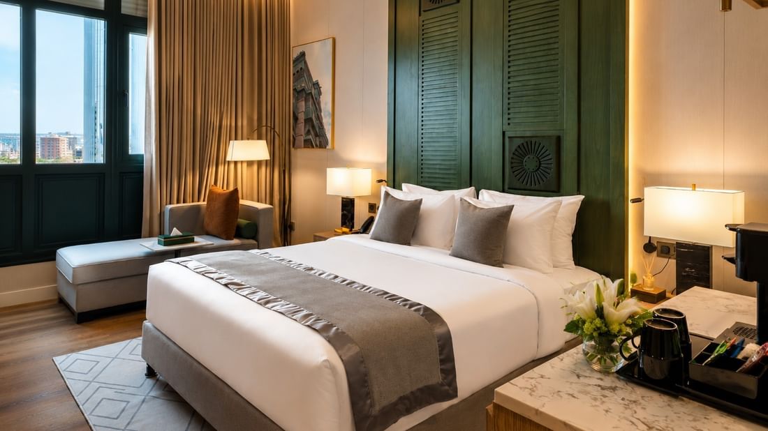 King bed near daybed in Deluxe Skyline View at Naviti by Warwick Jeddah, featuring spacious hotel rooms in Jeddah