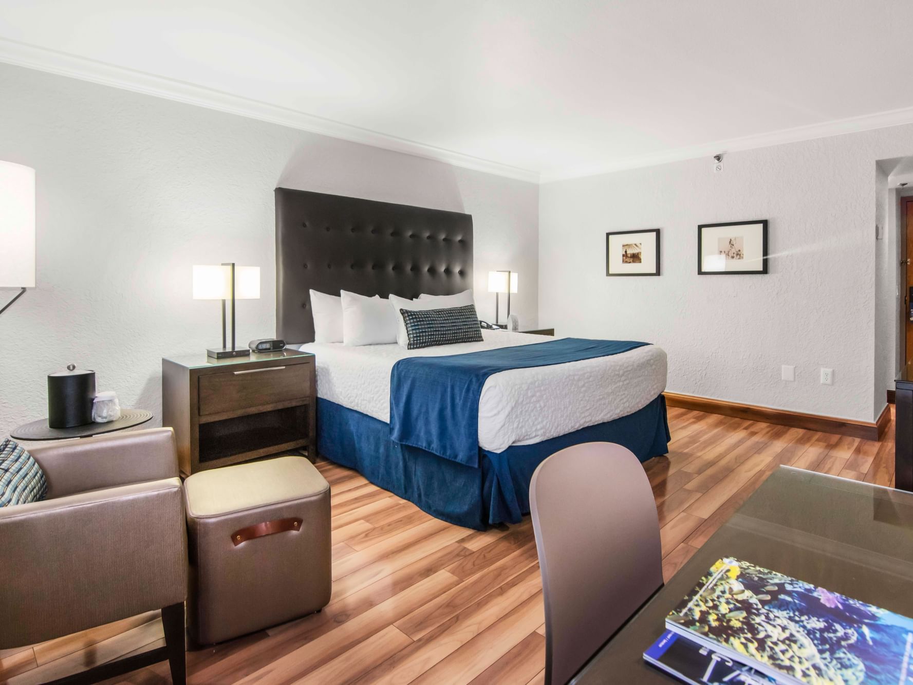 King bed and work area in Deluxe Room with wooden floors at Miami Lakes Hotel