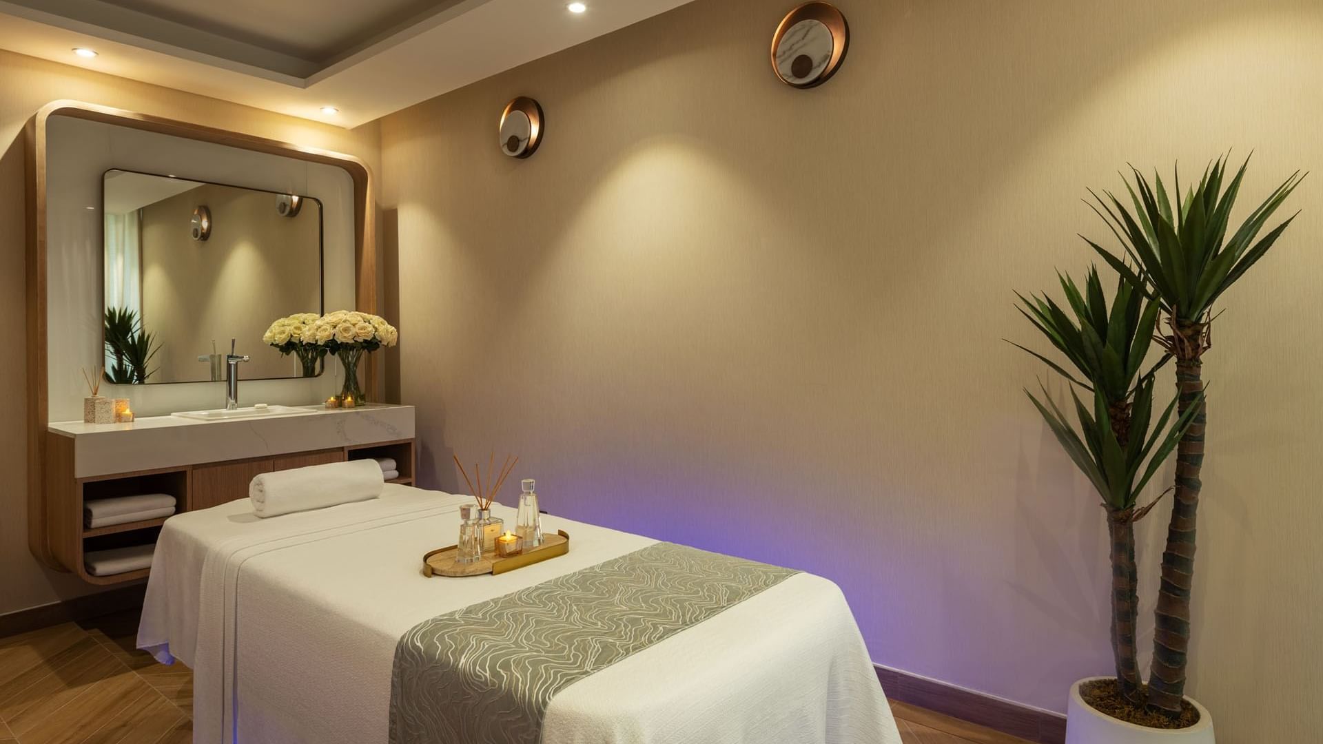 Tray with amenities on a massage bed in the Spa Treatment Room at DAMAC Maison Aykon City Hotel Apartments