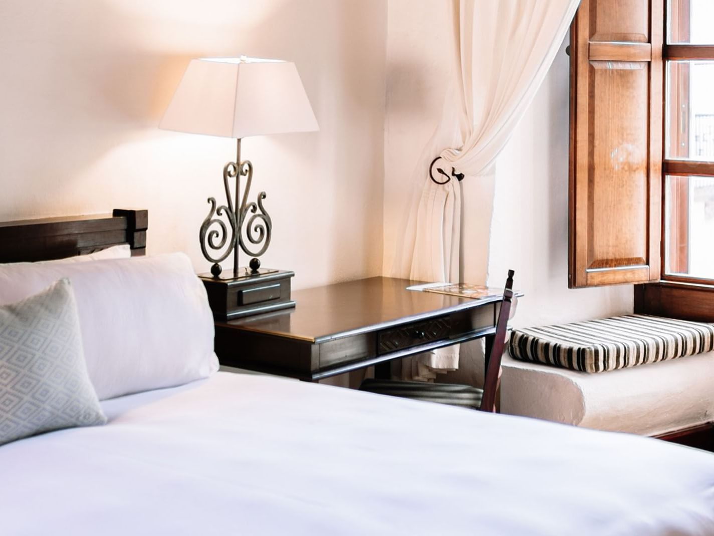 Nook and work desk by the cozy bed in the King Superior Suite at Quinta Real Oaxaca