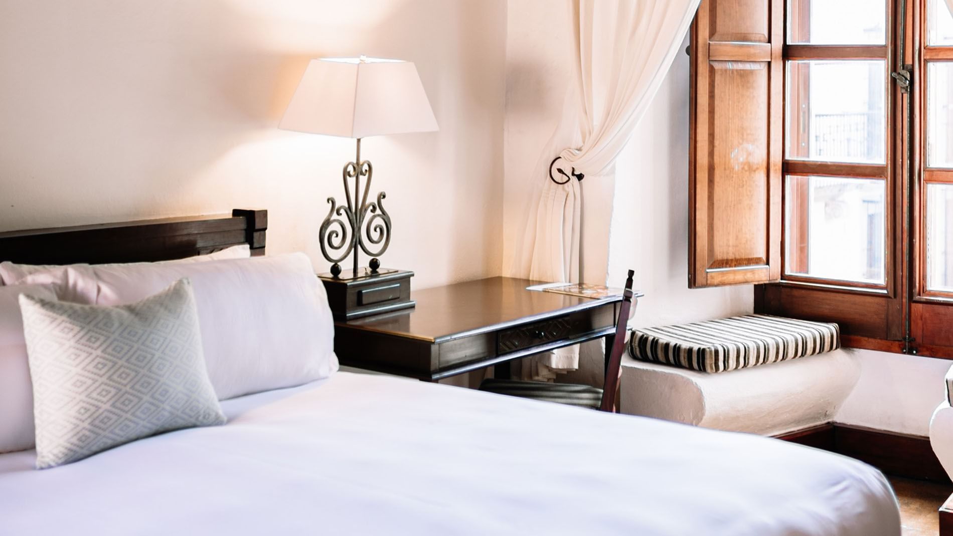 Nook and work desk by the cozy bed in the King Superior Suite at Quinta Real Oaxaca