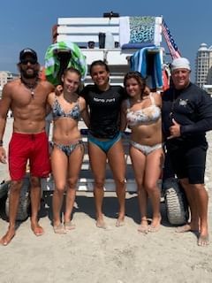 Group posing for a photo after a surf lesson in Diamond Beach at our hotel in Wildwood Crest