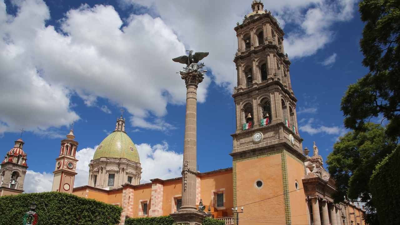 The Temple of Carmen, with an eagle statue stands next to a tall bell tower near Camino Real Pedregal Mexico