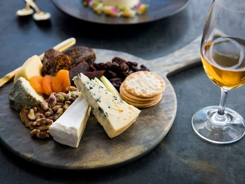 Cheese plate with a wine glass served at Pullman Magenta Shores