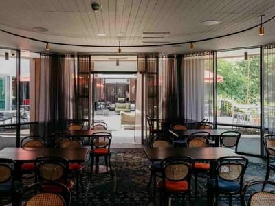Dining tables arranged in The Reserve Restaurant with an outdoor view at Amora Hotel Riverwalk Melbourne