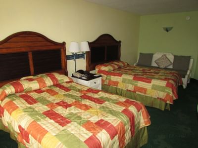 Hotel room with two beds, couch and nightstand