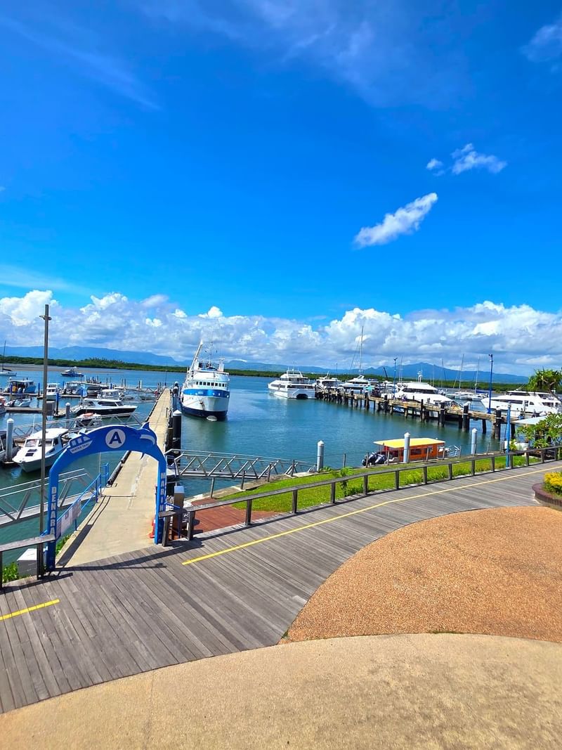 Wooden boardwalk leading to a Port Denarau Marina with various yachts and ferries near TokaToka Resort Nadi Fiji