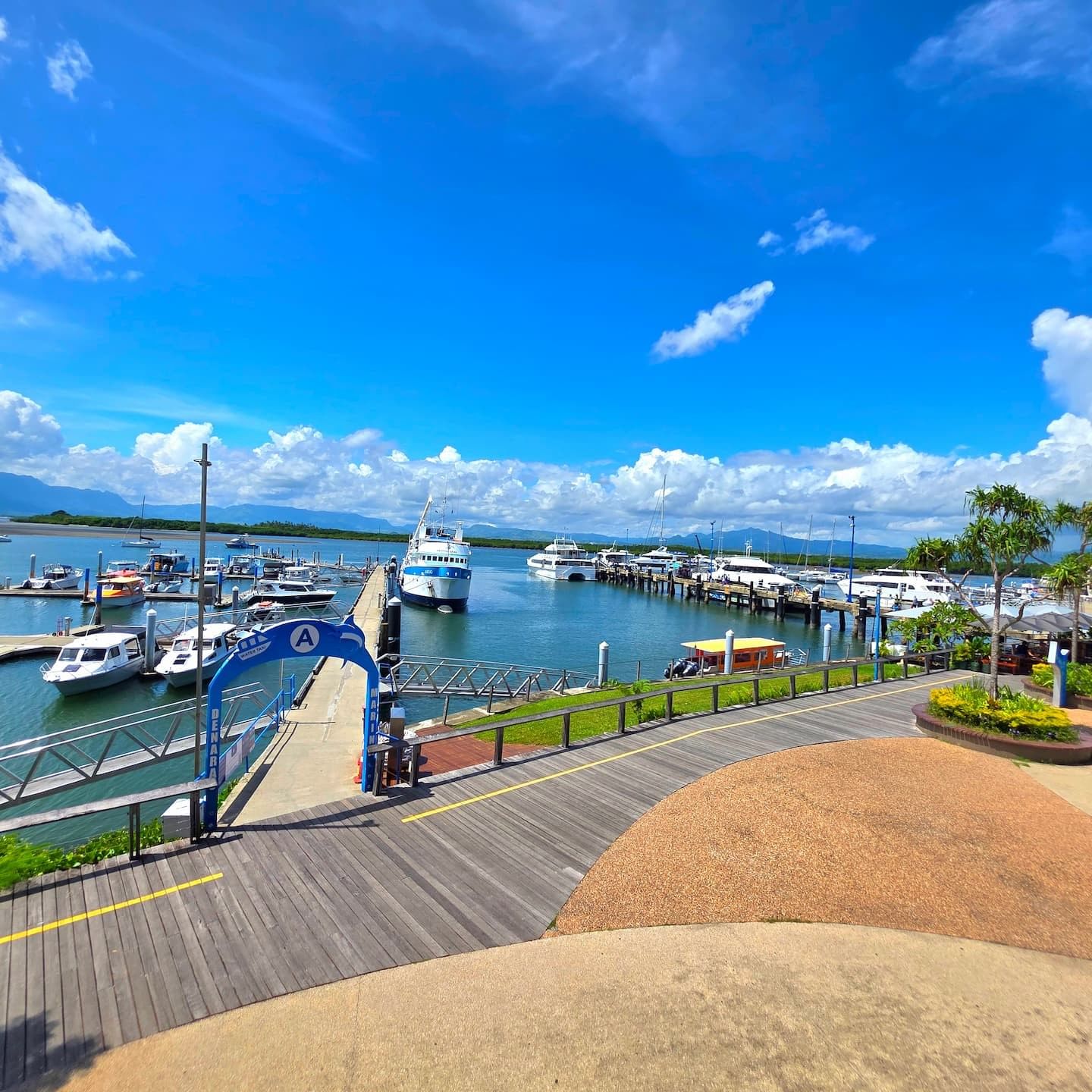 Wooden boardwalk leading to a Port Denarau Marina with various yachts and ferries near TokaToka Resort Nadi Fiji