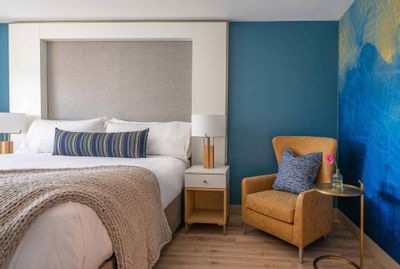 bed and sofa chair in hotel room