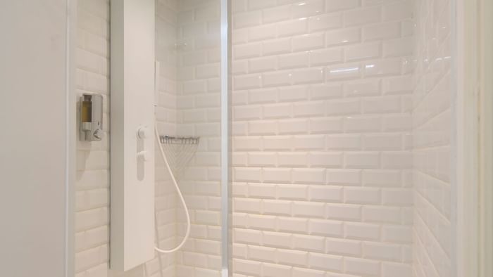 Modern shower set-up in a room at The Originals Hotels