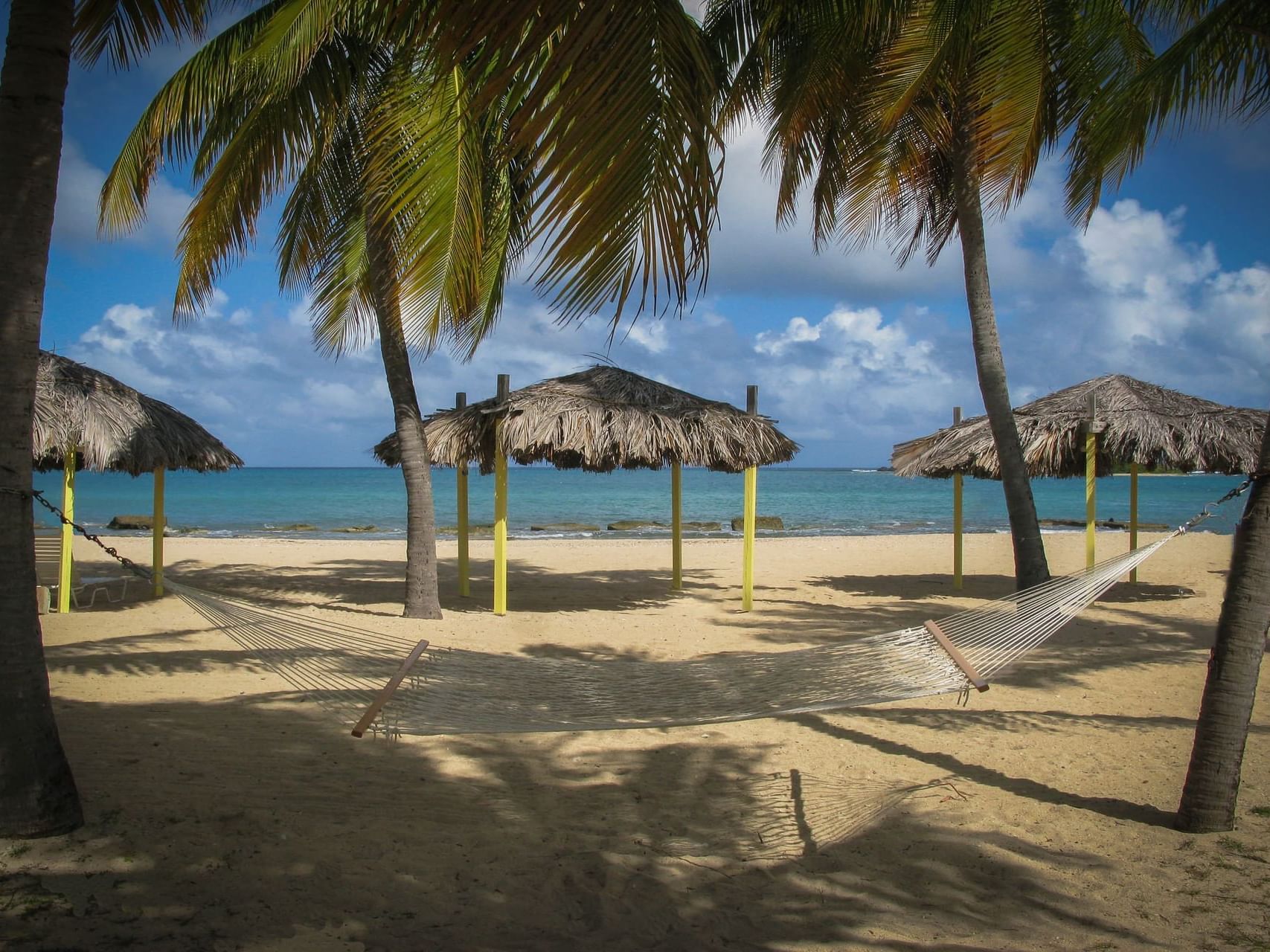 Hammock Tiki in the sea shore by beach at Tamarind Reef Resort 