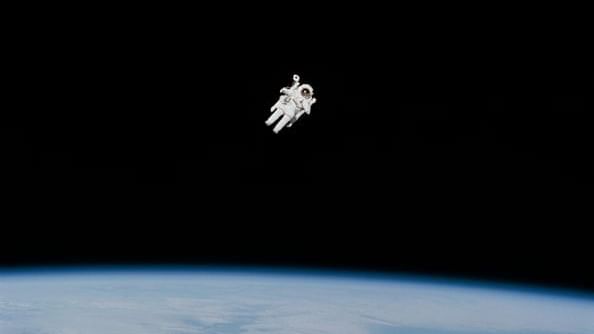 Astronaut spacewalking from Shuttle in outer space
