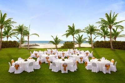 Banquet tables arranged in the Garden at Ajman Hotel