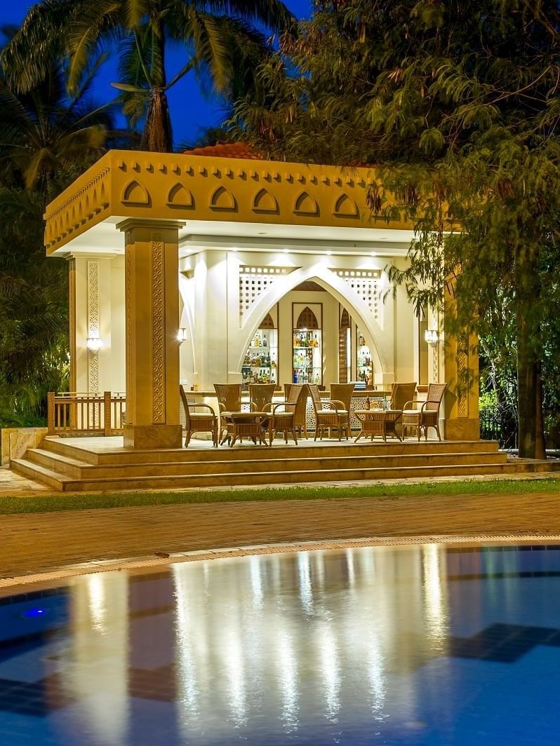 Outdoor pool bar with seating by a pool at Dar Es Salaam Serena Hotel in Dar es Salaam.
