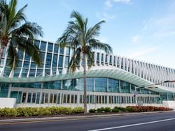 Miami Beach Convention Center features wavy facade of white vertical fins on a sunny day near The Plymouth Hotel South Beach