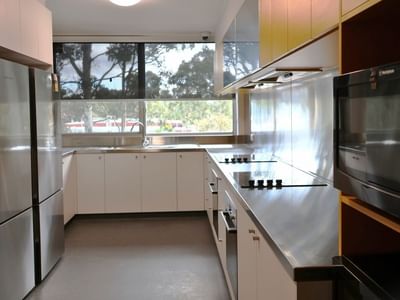 Modern kitchen with stainless steel appliances and white cabinets.