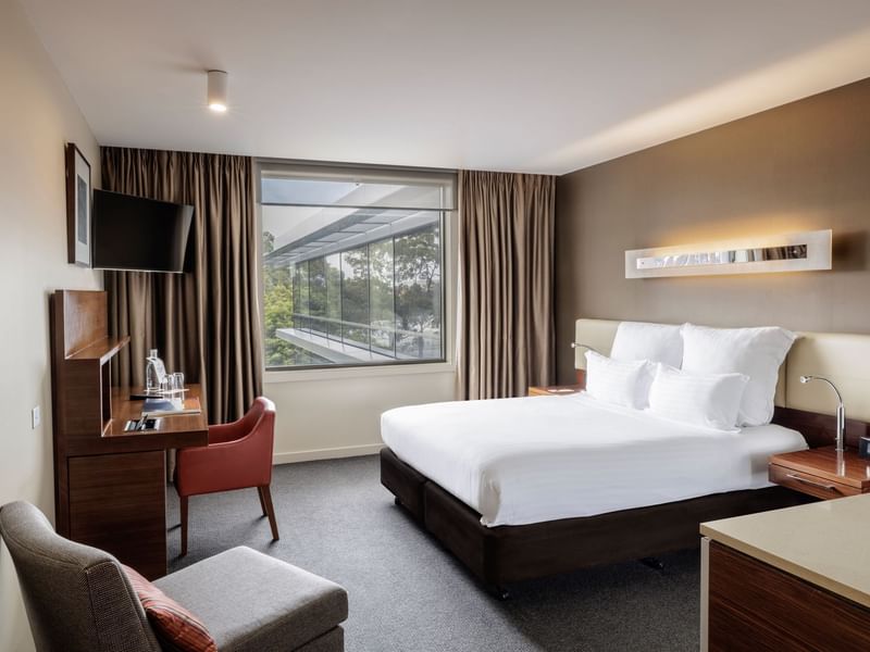 TV with workdesk facing bed by the window in Pullman Superior King Accessible Room 351 at Pullman Sydney Olympic Park