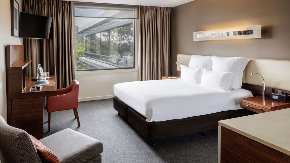 TV with workdesk facing bed by the window in Pullman Superior King Accessible Room 351 at Pullman Sydney Olympic Park