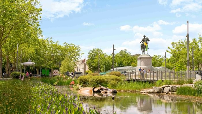 A stream with greens and statue near Hotel Napoleon 