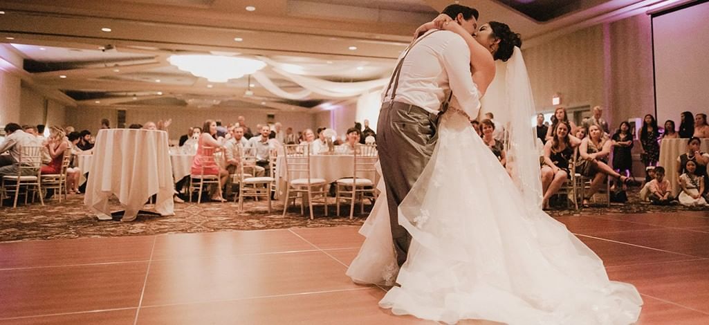 Bride and groom sharing their first dance on the ballroom floor