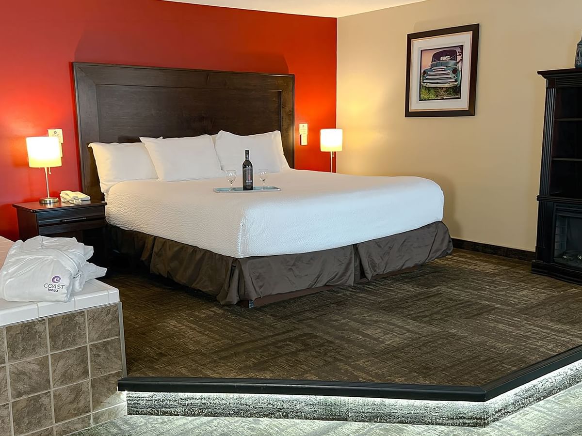 Jacuzzi tub and bed in hotel suite