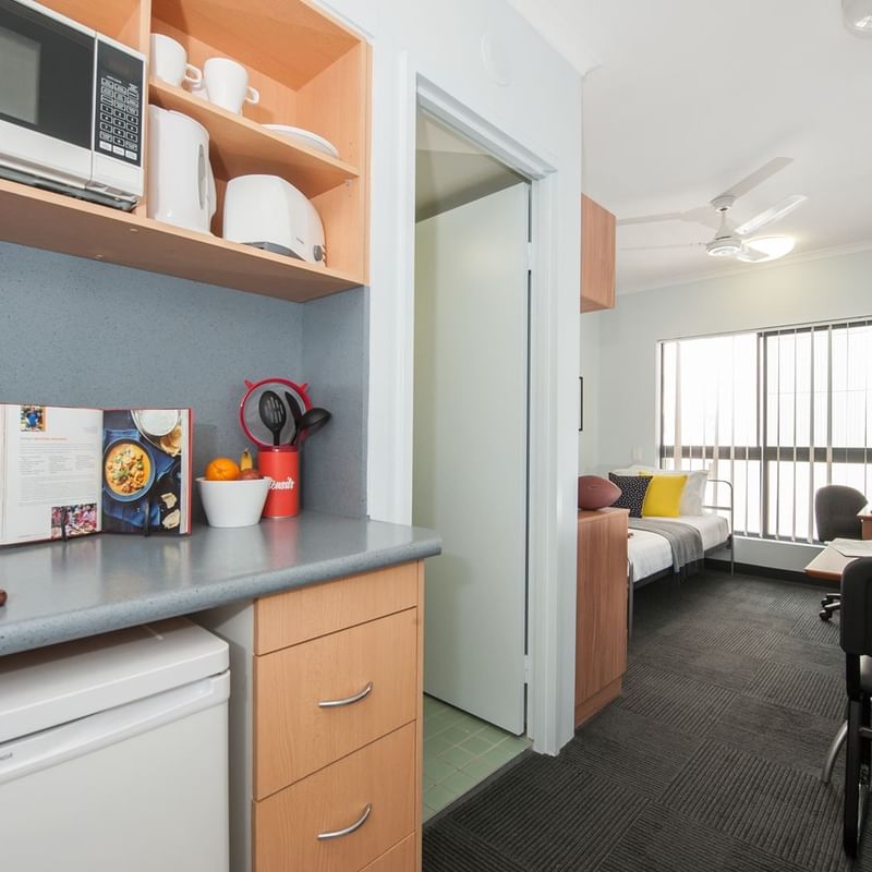 Modern studio apartment with kitchenette, dining area, and living space with natural light at UniLodge on Margaret