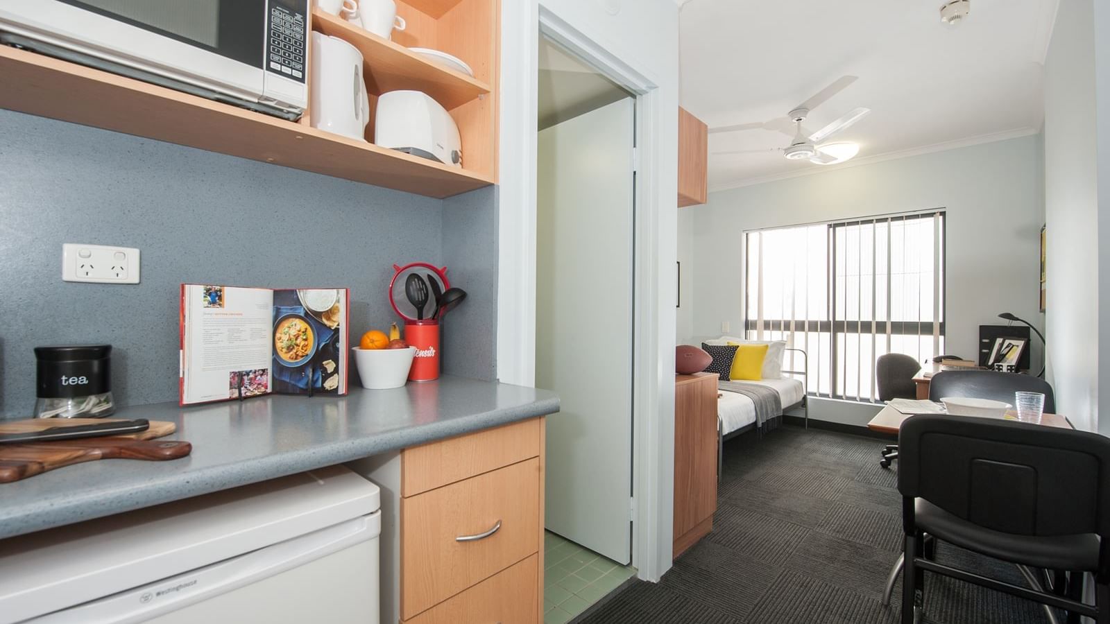 Modern studio apartment with kitchenette, dining area, and living space with natural light at StudentLiving - on Margaret