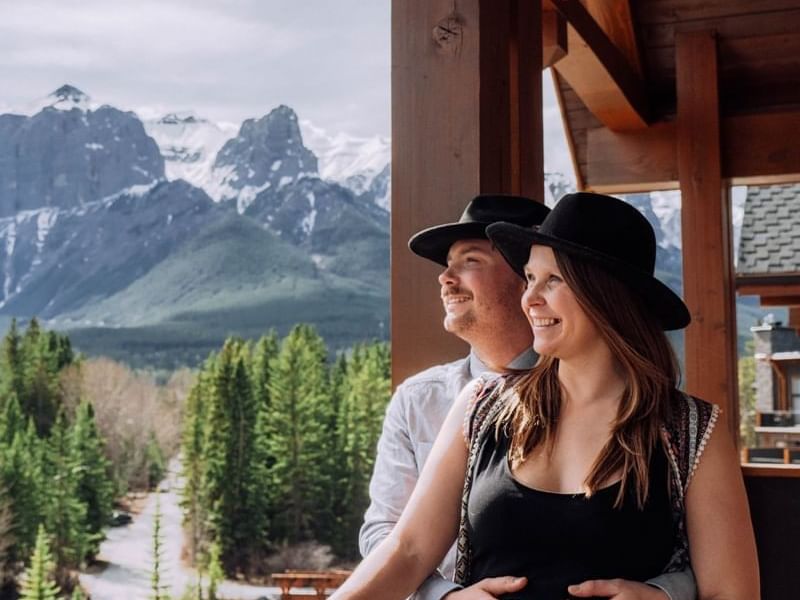 A couple overlooking the view from a balcony at Malcolm Hotel