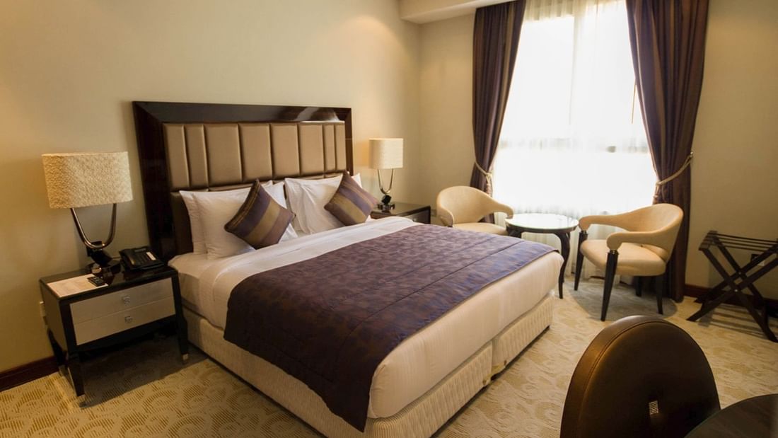 Deluxe Room with king bed & sitting area at Strato Hotel by Warwick Doha