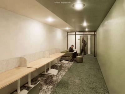 Interior view of a hallway with tables and seating at UniLodge Brisbane City.