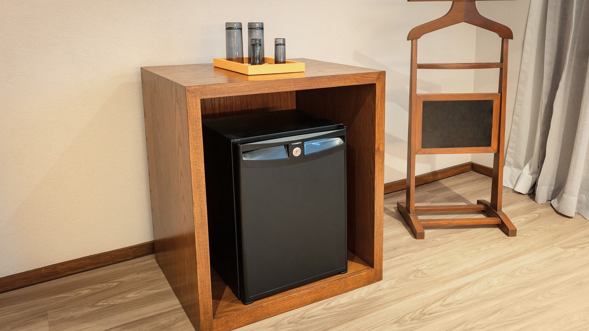 Refrigerador empotrado en mueble de madera en la Junior Suite 2 Camas Dobles del Camino Real Aeropuerto México en Ciudad de México.