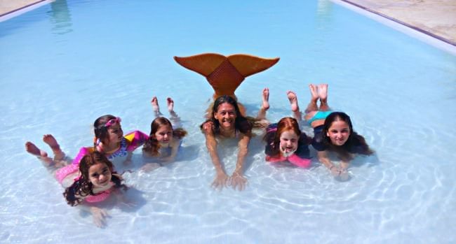 Kids enjoying in a pool near The Somerset On Grace Bay