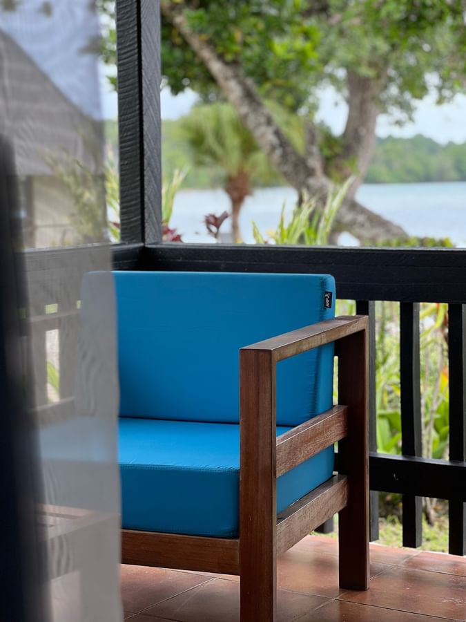 Blue cushioned chair on a balcony at Warwick Le Lagon - Vanuatu in Efate.