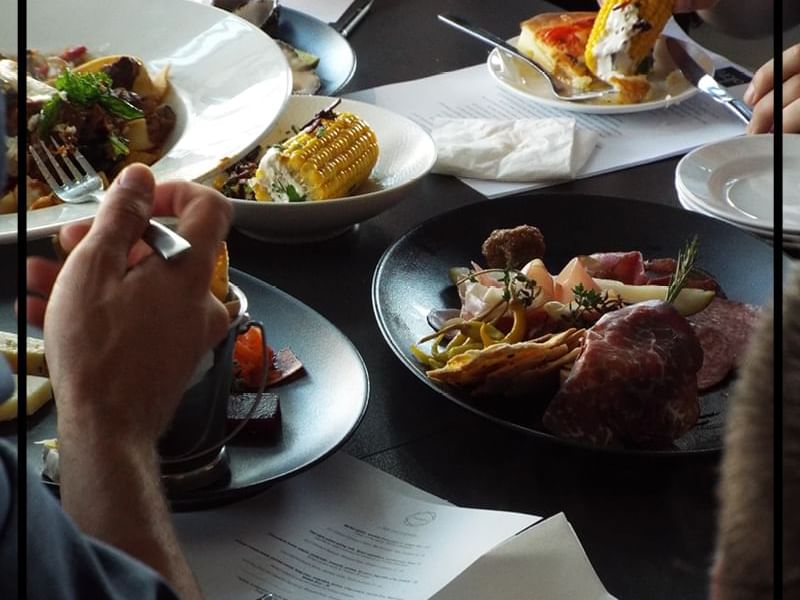 People enjoying a variety of dishes served at Pullman & Mercure Brisbane King George Square