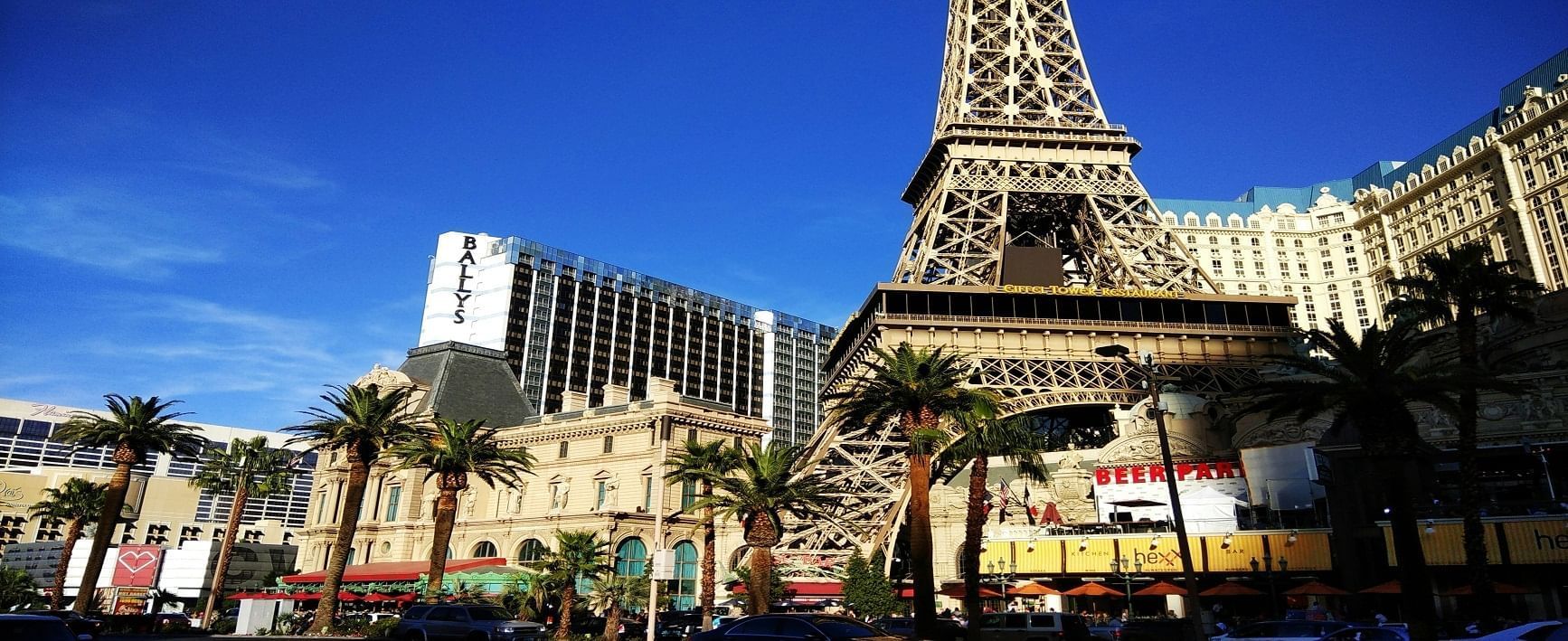 A photo of the Eiffel Tower in Las Vegas with palm trees in front of it.