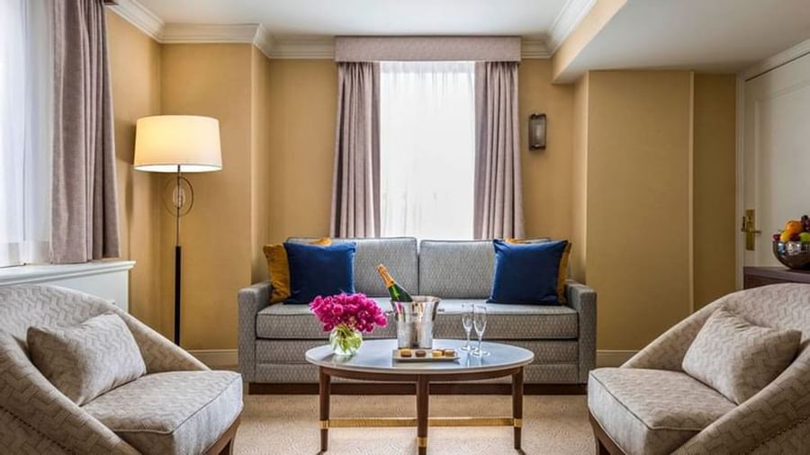 Executive King living area with a sofa & champagne on the coffee table near window at Warwick Allerton Chicago