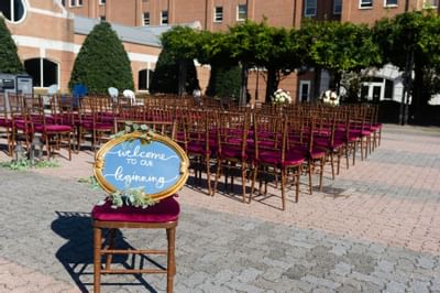 outdoor wedding venue with sign that says welcome to our beginni